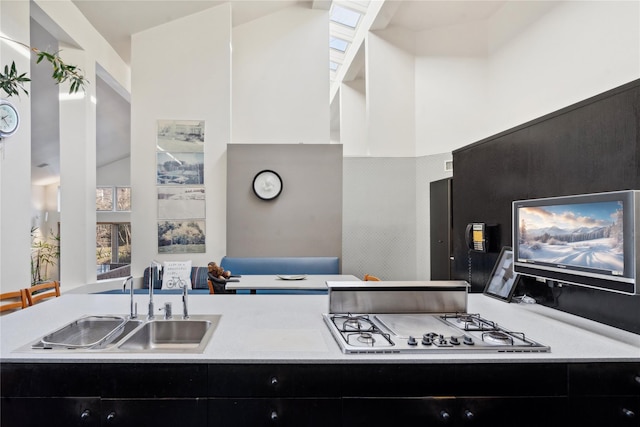 kitchen with lofted ceiling, sink, and gas cooktop