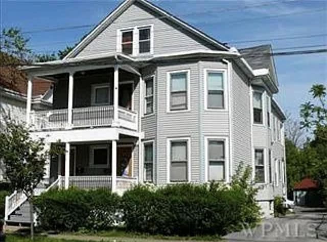 view of front facade featuring a balcony and covered porch