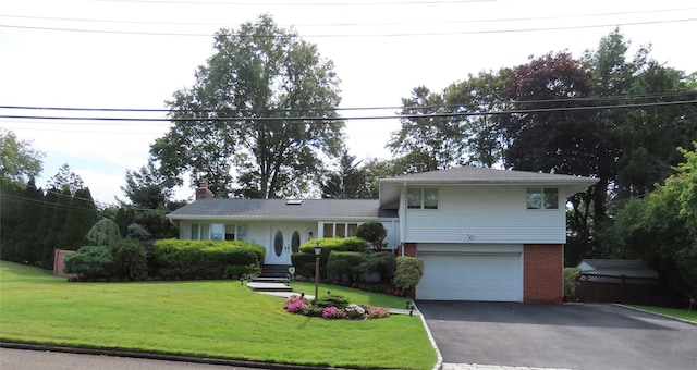 tri-level home with a garage and a front yard