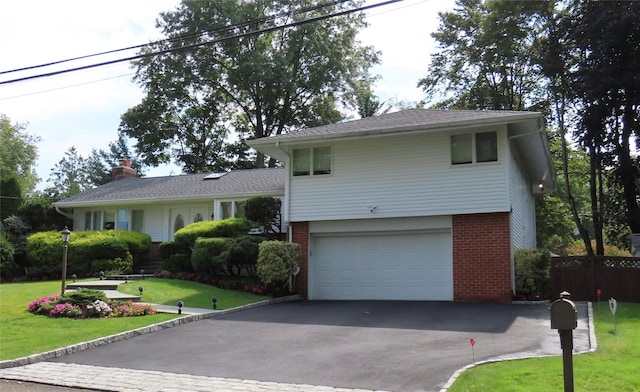 view of front of home with a garage and a front yard