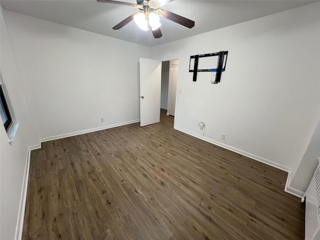 unfurnished bedroom featuring dark hardwood / wood-style flooring and ceiling fan