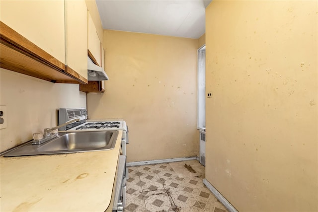 kitchen featuring sink, white cabinets, and white range with gas cooktop