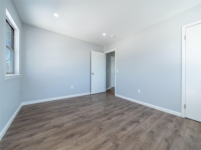 spare room with dark hardwood / wood-style flooring