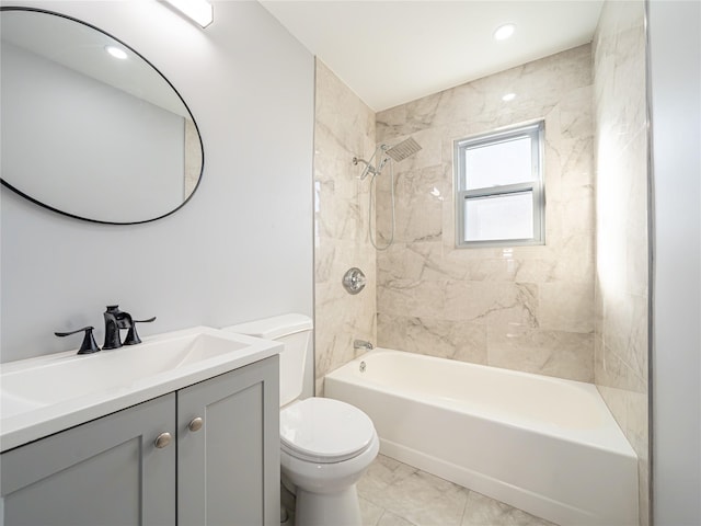 full bathroom with vanity, tiled shower / bath combo, tile patterned floors, and toilet