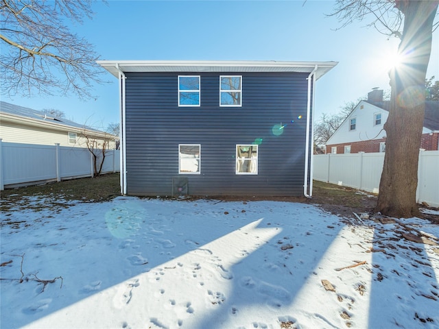 view of snow covered rear of property