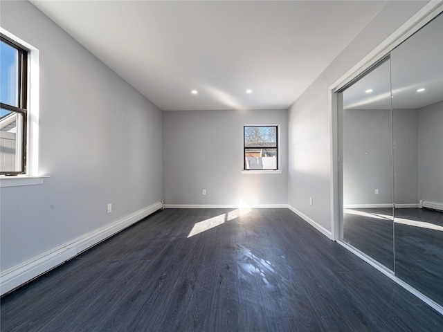 unfurnished room featuring dark wood-style floors, recessed lighting, baseboards, and baseboard heating