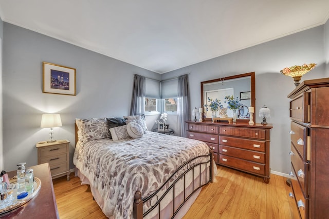 bedroom featuring light wood-style floors and baseboards