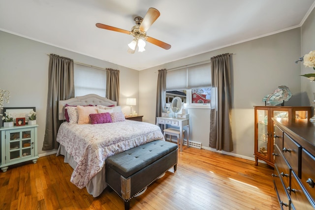 bedroom with ceiling fan, light wood finished floors, ornamental molding, and baseboards