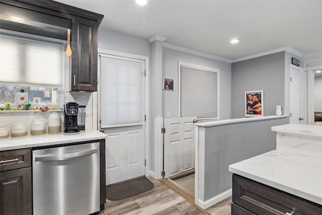 kitchen with stainless steel dishwasher, dark brown cabinets, decorative light fixtures, and light hardwood / wood-style flooring