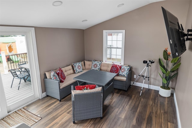 living room with dark wood-type flooring and vaulted ceiling