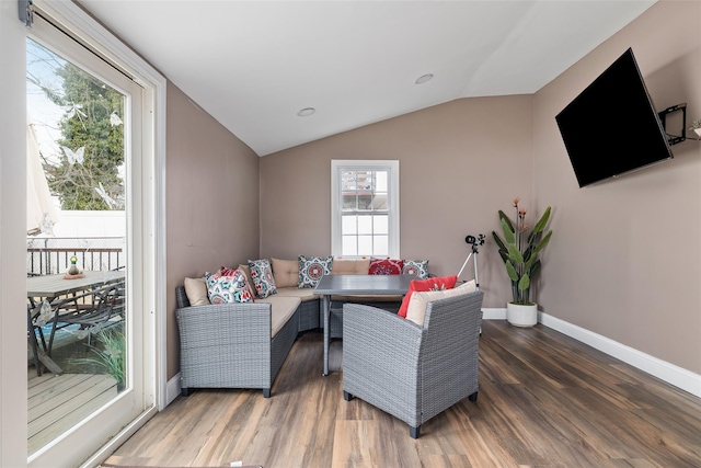 living room featuring dark wood-type flooring and vaulted ceiling