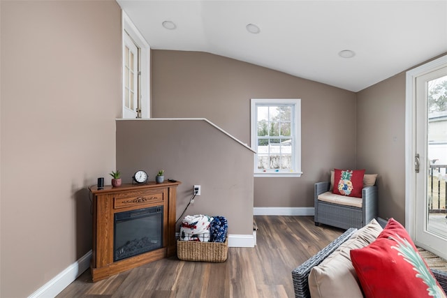 living area featuring vaulted ceiling and dark hardwood / wood-style floors