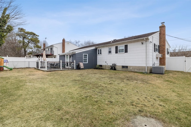 back of house with a yard, a deck, and central air condition unit