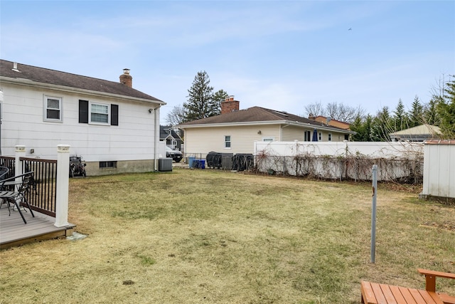 view of yard featuring cooling unit and a wooden deck