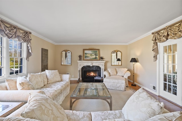 living room with ornamental molding and light hardwood / wood-style floors