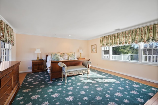 bedroom with hardwood / wood-style flooring and ornamental molding