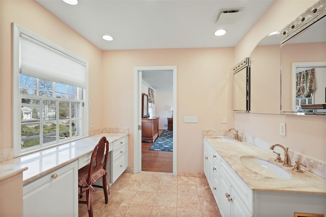 bathroom featuring tile patterned flooring and vanity