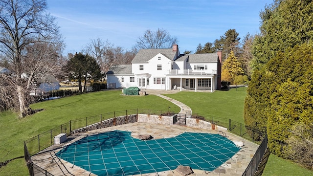 view of pool featuring a yard and a patio