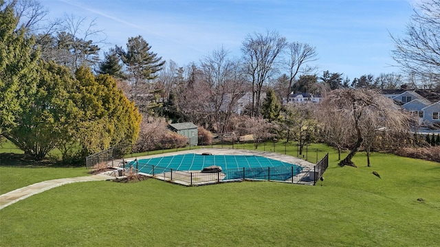 view of swimming pool featuring a yard