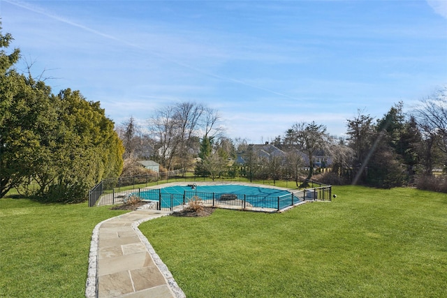 view of pool featuring a lawn