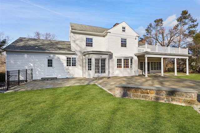 rear view of property with a yard and a patio