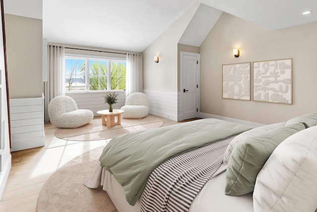 bedroom featuring vaulted ceiling and light wood-type flooring