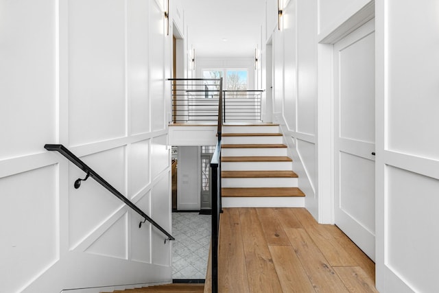 stairway with hardwood / wood-style flooring