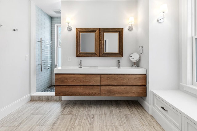 bathroom with vanity, hardwood / wood-style floors, and a tile shower