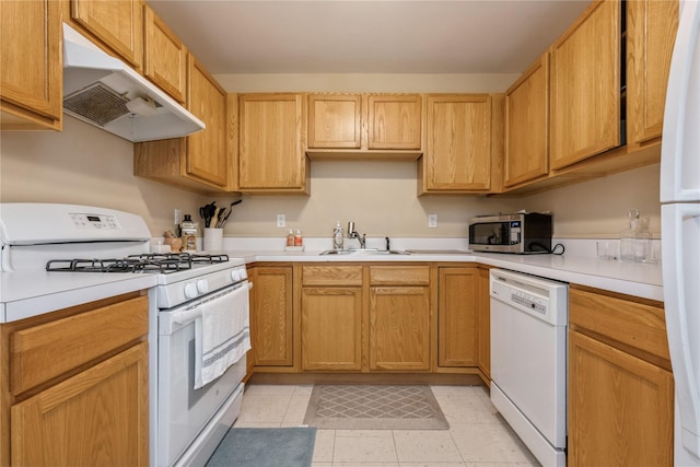 kitchen with white appliances, sink, light brown cabinets, and light tile patterned floors