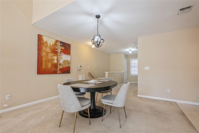 carpeted dining space featuring a chandelier