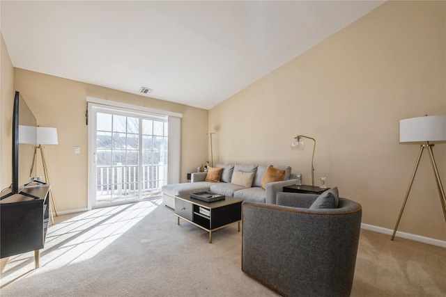 carpeted living room featuring vaulted ceiling