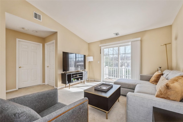 carpeted living room featuring lofted ceiling