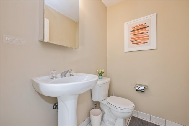 bathroom with sink, tile patterned floors, and toilet