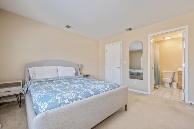 carpeted bedroom featuring connected bathroom