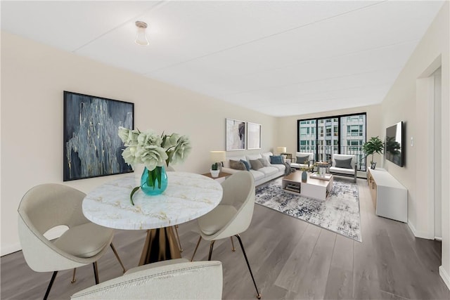 dining space featuring a wall of windows and hardwood / wood-style floors