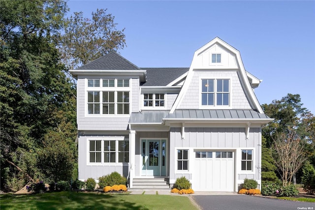 view of front of property featuring a garage and a front yard