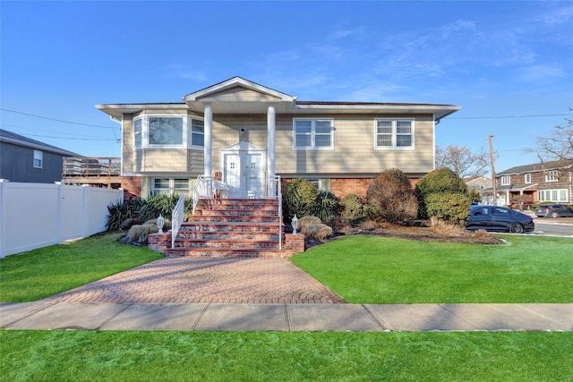 raised ranch featuring a front lawn