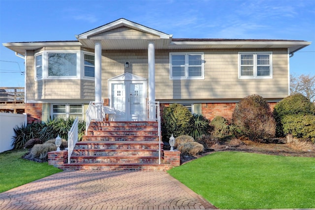 bi-level home with a front lawn