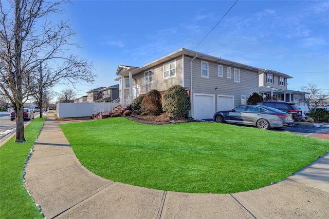 view of home's exterior with a garage and a lawn