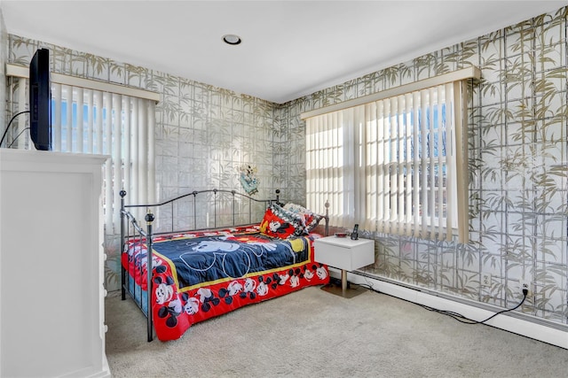 carpeted bedroom with a baseboard heating unit