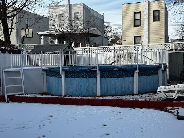 snow covered pool with a deck