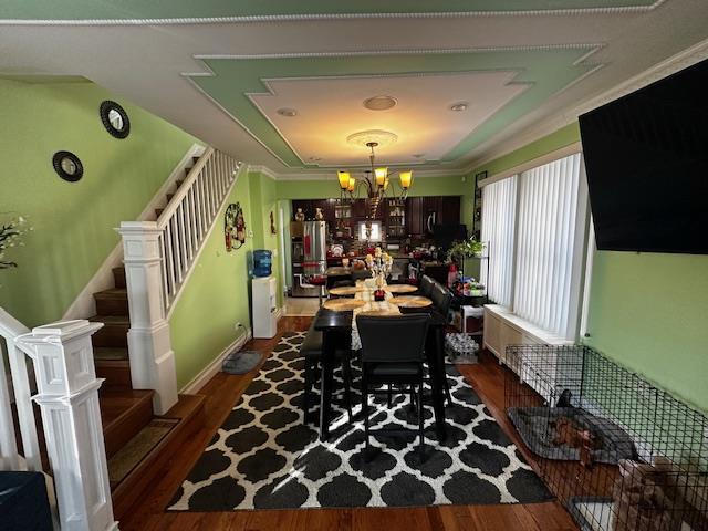 office space with ornamental molding, dark hardwood / wood-style floors, and a notable chandelier