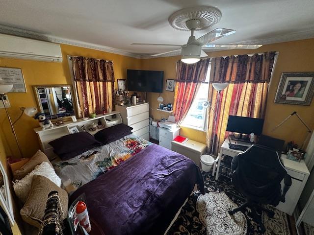 bedroom with ornamental molding and an AC wall unit