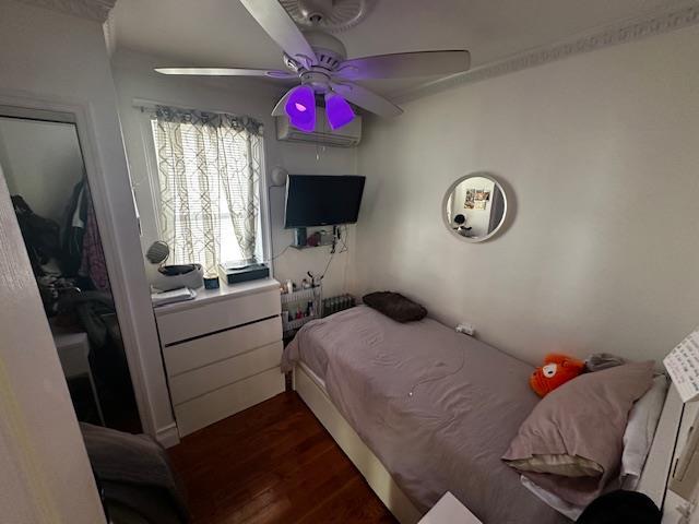 bedroom featuring dark wood-type flooring and ceiling fan