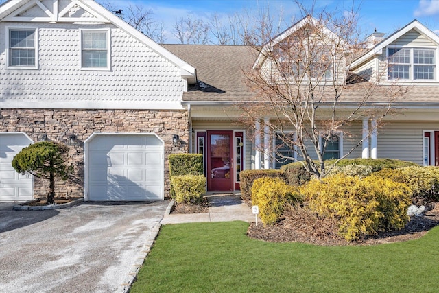 view of front of home with a garage and a front yard