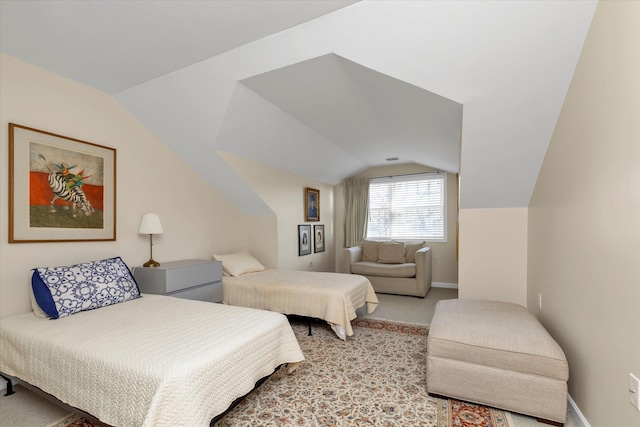 bedroom with vaulted ceiling and light carpet