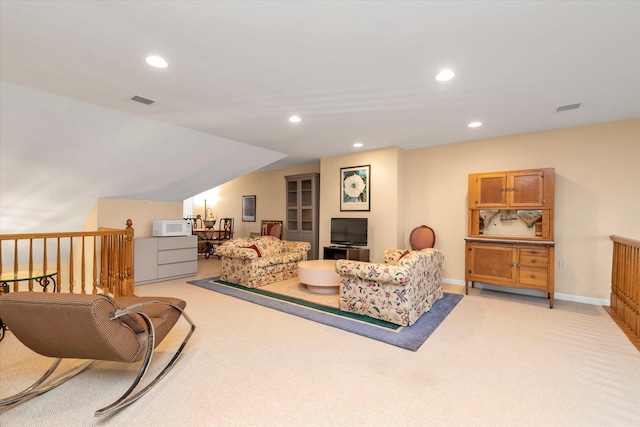 carpeted living room with lofted ceiling