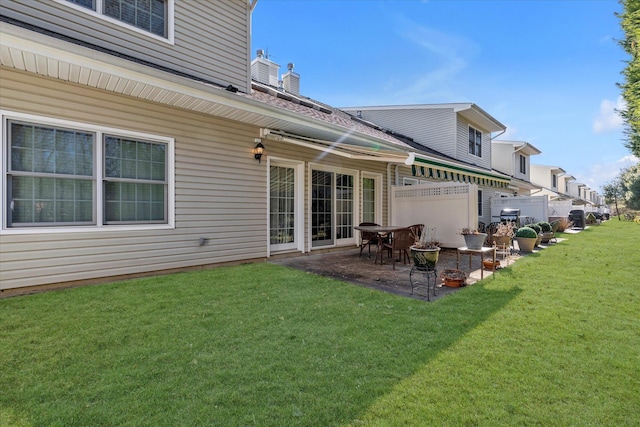 rear view of house with a yard and a patio area