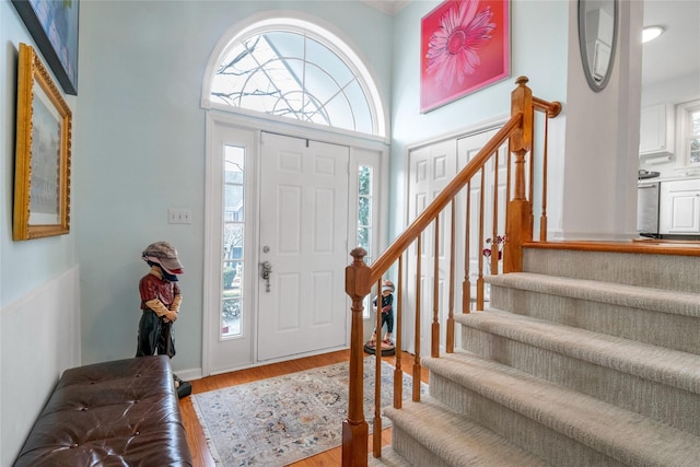 entrance foyer with wood-type flooring and a high ceiling