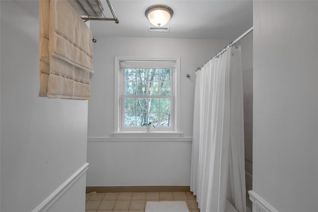 bathroom featuring walk in shower and tile patterned floors